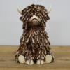 Sitting Highland Cow