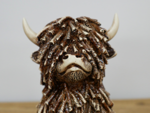 Sitting Highland Cow